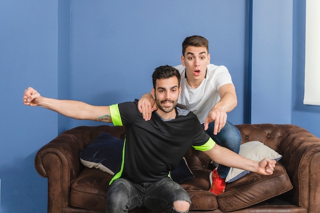 Football fans celebrating in living room