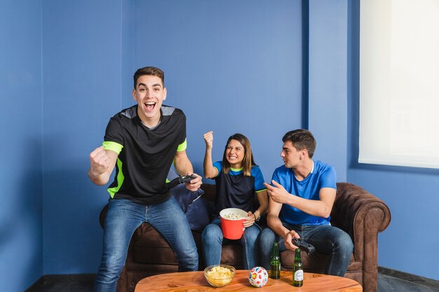 Football fans celebrating in living room