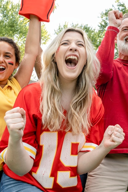 Football fans celebrating the win of their team at a tailgate party