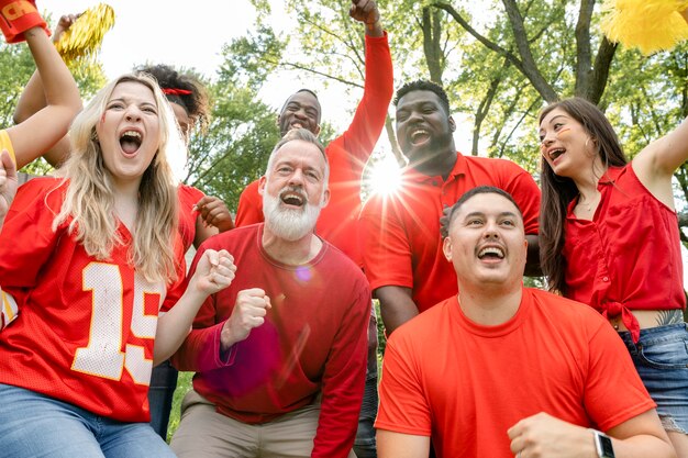 Football fans celebrating the win of their team at a tailgate party