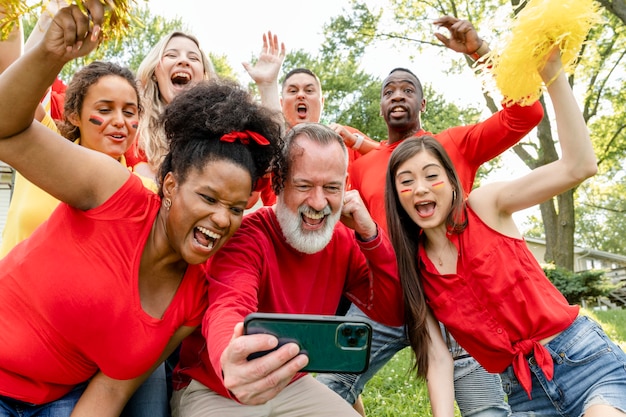 Football fans celebrating the win of their team at a tailgate party