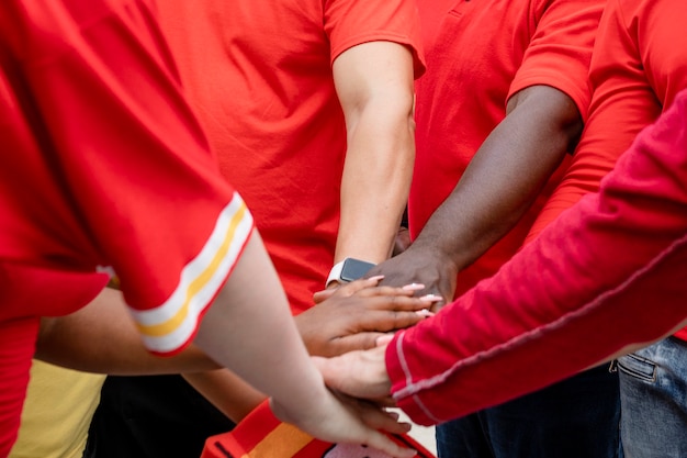 Football fans in a huddle at a tailgate party