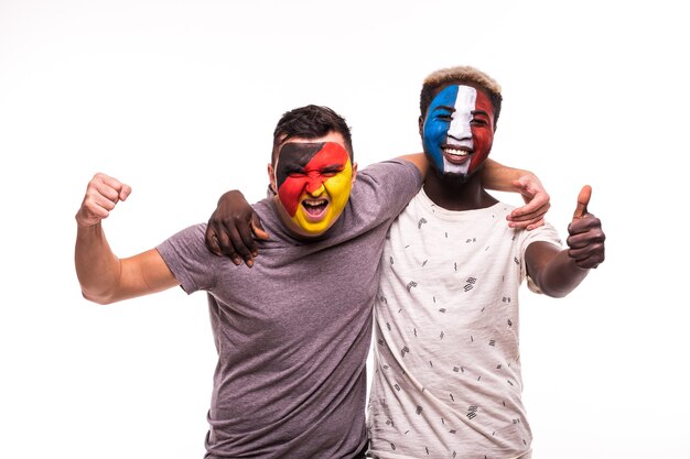 Football fans supporters with painted face of national teams of France and Germany isolated on white background