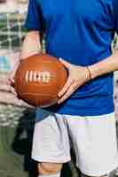 Free photo football player holding ball