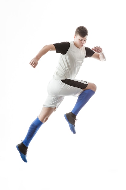 Football player jumping on white background