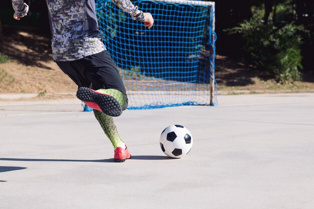 Premium Photo Football Player Kicking The Ball Into Empty Goal