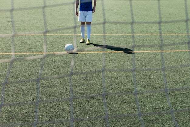 Free photo football player behind net