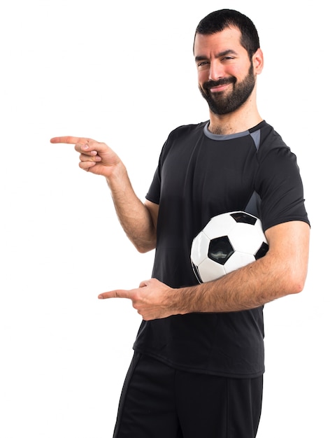 Free photo football player pointing to the lateral