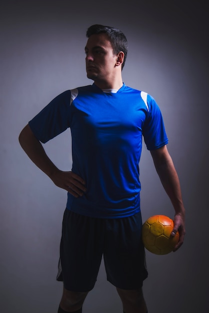 Football player posing with ball