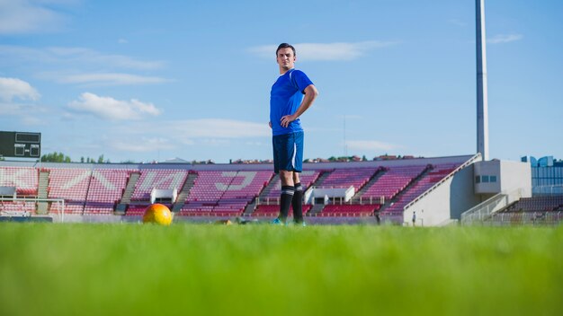 Football player in stadium preparing for free kick