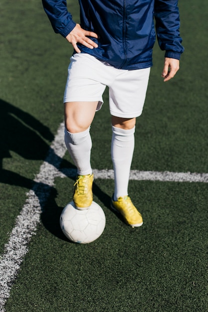 Football player with foot on ball