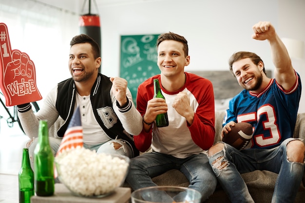 Football supporters cheering at home