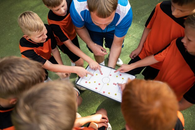 Football trainer teaching his pupils