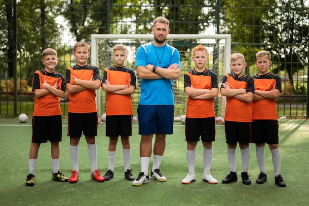 Free photo football trainer teaching his pupils