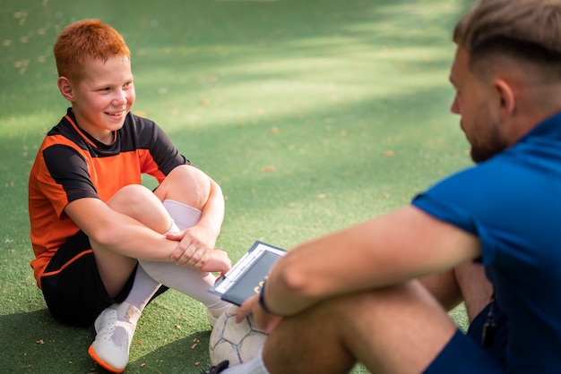 Free photo football trainer teaching his pupils