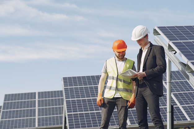 Foreman and businessman at solar energy station.