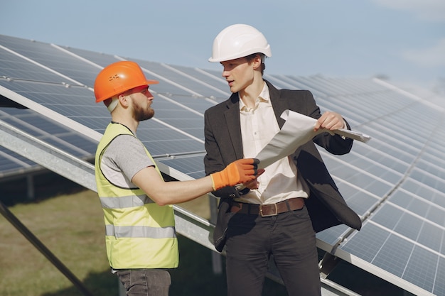 Foreman and businessman at solar energy station.