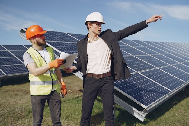 Foreman and businessman at solar energy station.