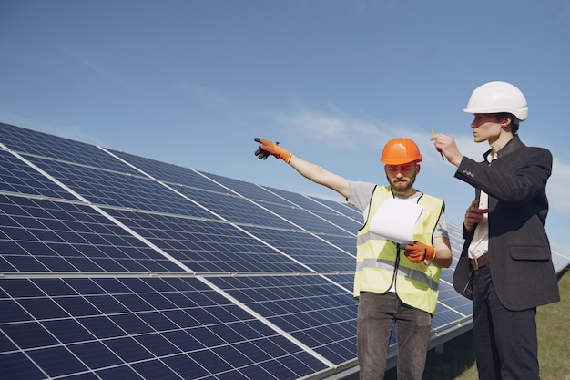 Foreman and businessman at solar energy station.