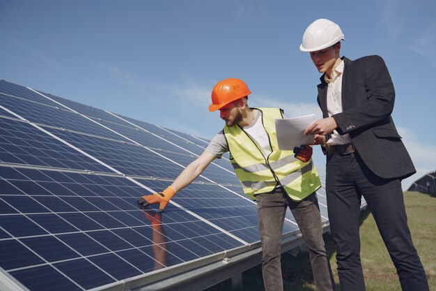 Foreman and businessman at solar energy station.