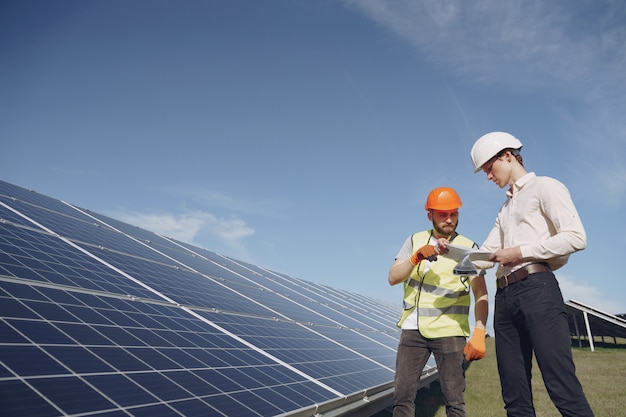 Foreman and businessman at solar energy station.