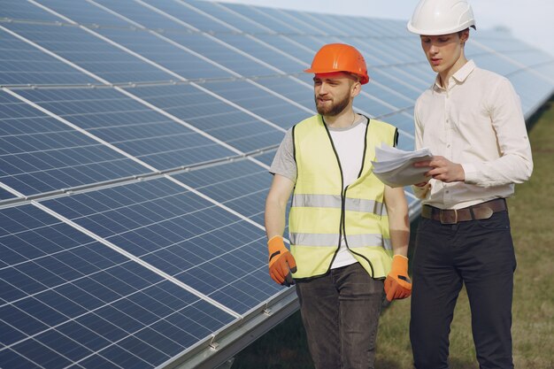 Foreman and businessman at solar energy station.