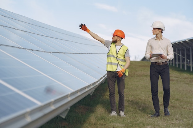 Foreman and businessman at solar energy station.