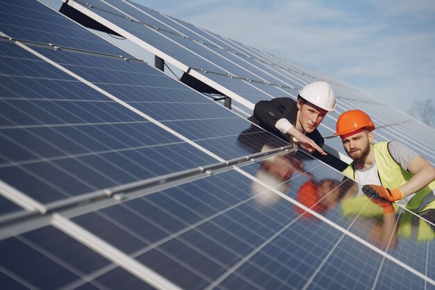 Foreman and businessman at solar energy station.