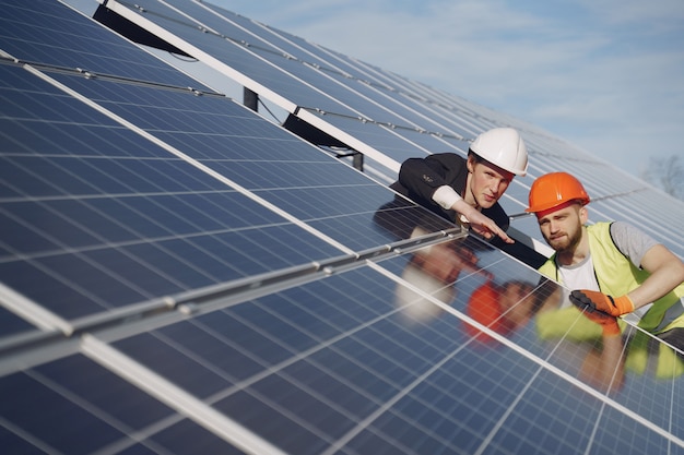 Foreman and businessman at solar energy station.