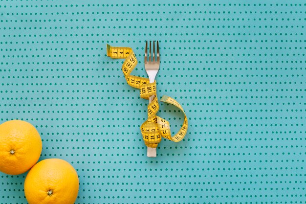 Fork, tape measure and oranges