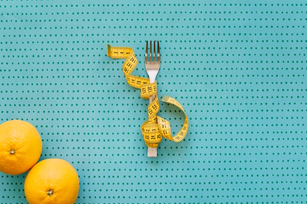 Fork, tape measure and oranges