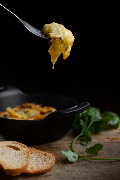 Fork with melted cheese and toast