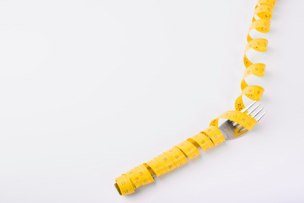 Free photo fork in yellow measuring tape