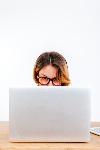 Formal woman sitting behind laptop