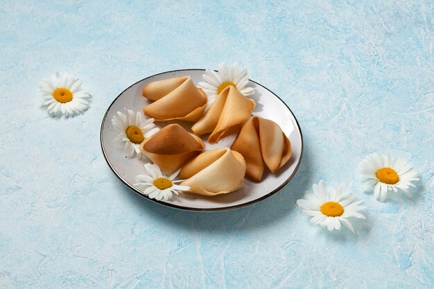 Fortune cookies and flowers high angle