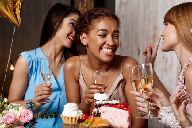 Four beautiful girls resting at party.