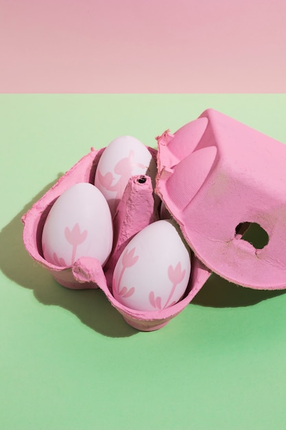 Four bright Easter eggs in rack on table