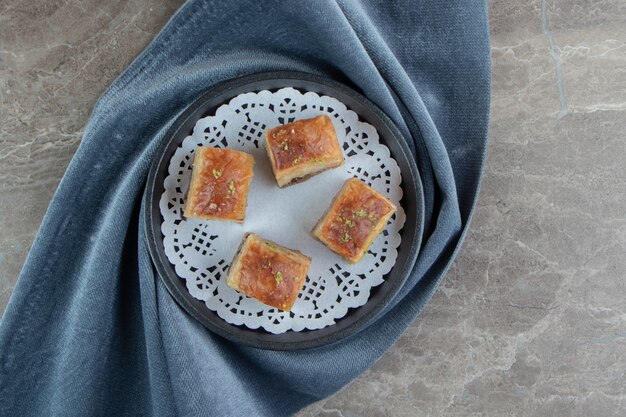 Free photo four delicious baklava on dark plate