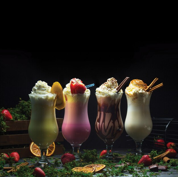 Four different cocktail smoothies with milky cream on the top