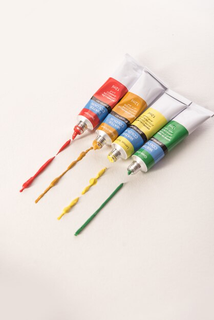 Four different tubes with watercolor paint isolated