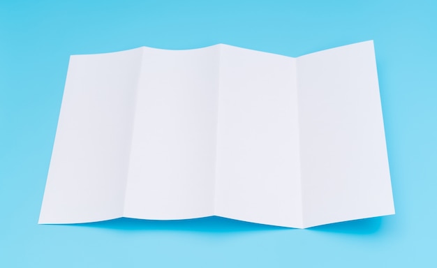 Four- fold white template paper on blue background .