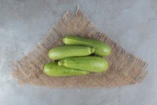 Four fresh zucchini vegetables on a sackcloth . High quality photo