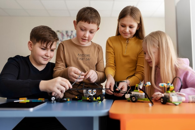 Four kids building a drone using electronic parts