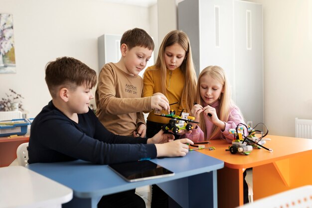 Four kids building a drone using electronic parts