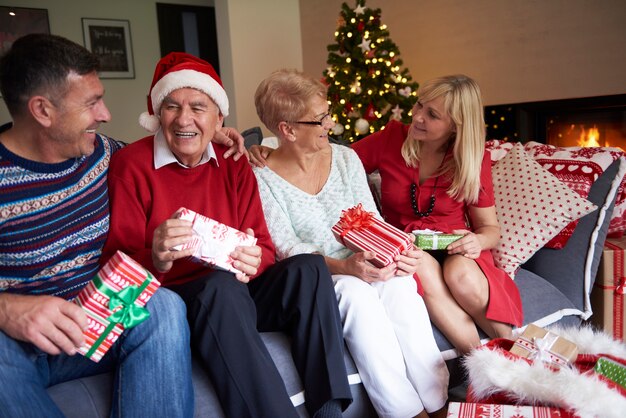 Four people in the living room on Christmas