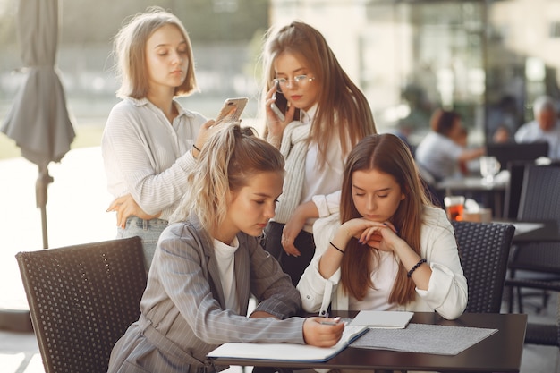 Four students on a student campus sitting at the table