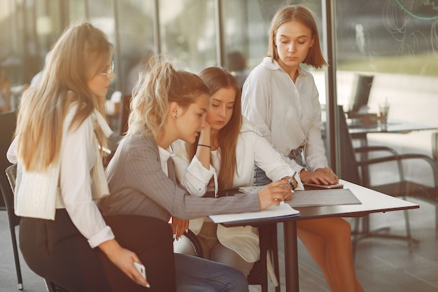 Four students on a student campus sitting at the table