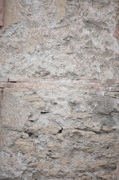 Fragment of old grungy texture with chipped paint and cracks or grey concrete wall and cement surface