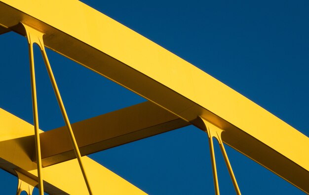 Fragments of a modern yellow construction with a blue background