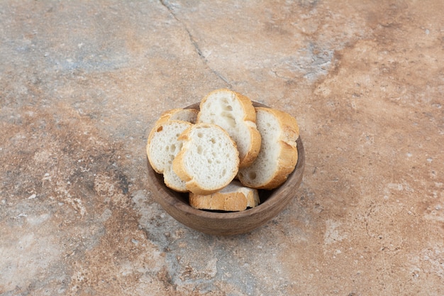 Fragrant bread slices in wooden bowl